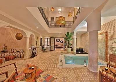 a large room with a swimming pool in a house at Riad Al Badia in Marrakech