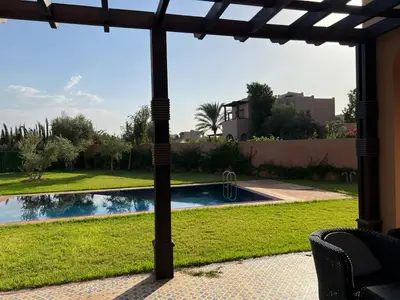 a view of a swimming pool from a patio at Konouz Palace in Marrakech