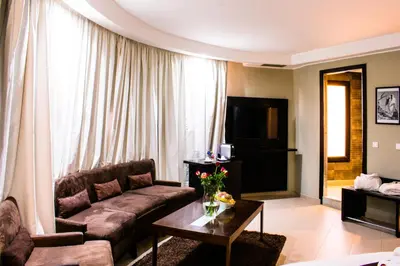 a living room with a couch and a table at Tempoo Hotel Marrakech City Centre Adults Only in Marrakech