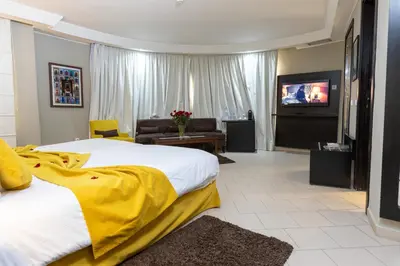 a hotel room with two beds and a flat screen tv at Tempoo Hotel Marrakech City Centre Adults Only in Marrakech