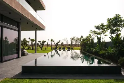 a pool of water in front of a building at VIP villa in Marrakech