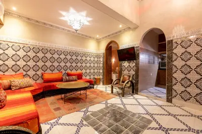a living room with a couch and a table at Riad Dali in Marrakech