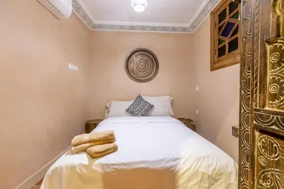 a bedroom with a bed with towels on it at Riad Dali in Marrakech