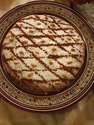 a cake on a plate on a table at Riad Hadda in Marrakech