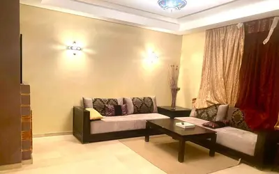 a living room with a couch and a coffee table at Charm & Chic Résidence in Marrakech