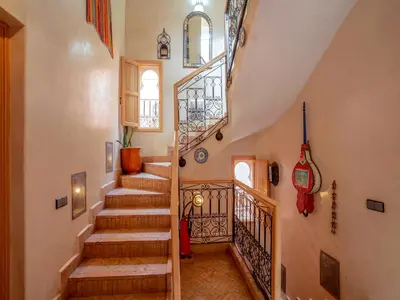 a staircase in a home with wooden steps at Riad Dar Nakhla in Marrakech