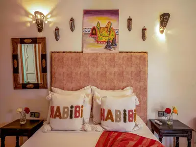 a bedroom with a bed with two pillows on it at Riad Dar Nakhla in Marrakech