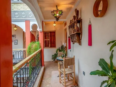 a hallway of a house with a table and chairs at Riad Dar Nakhla in Marrakech