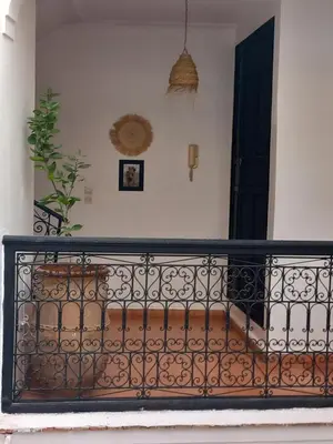 a balcony with a iron fence and a black door at Riad Hostel JAD ZIAD in Marrakech