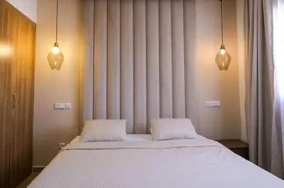 a bed with two white pillows in a bedroom at Appart très élégant avec piscine in Marrakech