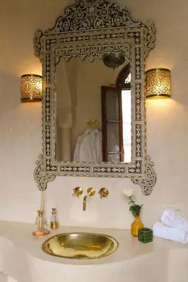 a bathroom with a sink and a mirror at Riad El Morocco Hotel in Marrakech