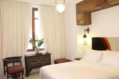 a hotel room with a bed and a window at Riad El Morocco Hotel in Marrakech
