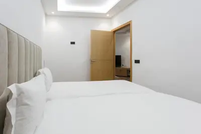 a bedroom with a white bed and a window at The Grand Medina Hideaway - Marrakech Centre in Marrakech