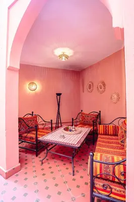 a room with a table and chairs and a couch at The Grand Medina Hideaway - Marrakech Centre in Marrakech