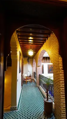 an archway with a table and a potted plant on a balcony at Riad Touhfa Kasbah Marrakech in Marrakech