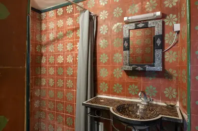 a bathroom with a sink and a mirror at Riad Arabesque in Marrakech