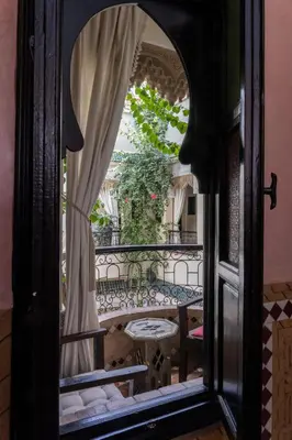a view of a balcony through a glass door at Riad Arabesque in Marrakech