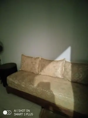 a couch with two pillows in a room at Chrifia in Marrakech