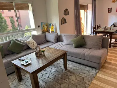 a living room with a couch and a coffee table at belle appartement a Marrakech in Marrakech
