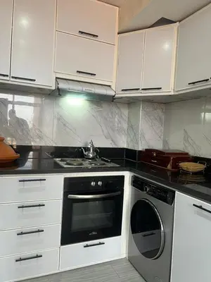 a kitchen with white cabinets and a dishwasher at Appartement Marrakech Gueliz 5 Min Drive to City Center in Marrakech