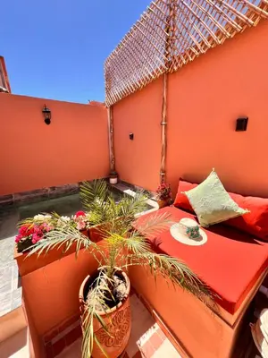 a balcony with a couch and potted plants on it at Riad Jardin de Malia in Marrakech