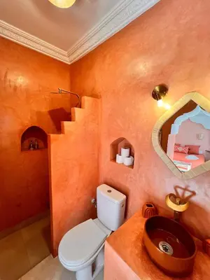 a bathroom with a toilet and a sink at Riad Jardin de Malia in Marrakech