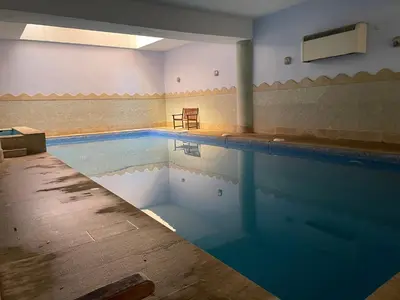 a swimming pool with a table and a chair at Apartment Gueliz in the best location in Marrakesh in Marrakech