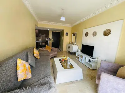 a living room with a couch and a table at Apartment Gueliz in the best location in Marrakesh in Marrakech