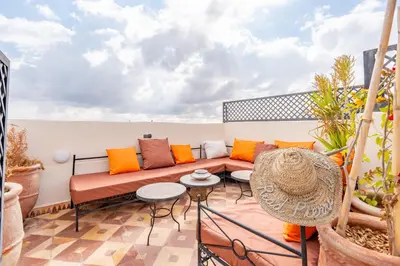 a balcony with a couch and a table at Riad médina- 3 Rooms Marrakech in Marrakech