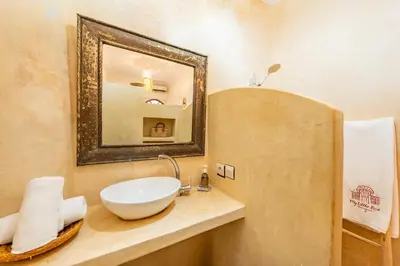 a bathroom with a sink and a mirror at Riad médina- 3 Rooms Marrakech in Marrakech