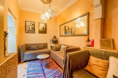a living room with a couch and a chair at Riad médina- 3 Rooms Marrakech in Marrakech