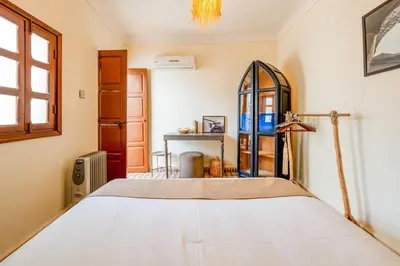 a bedroom with a bed and a window at Riad médina- 3 Rooms Marrakech in Marrakech