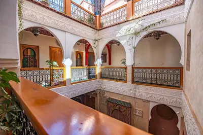 an ornate staircase in a building with wooden railings at Riad N 15 Zefriti in Marrakech