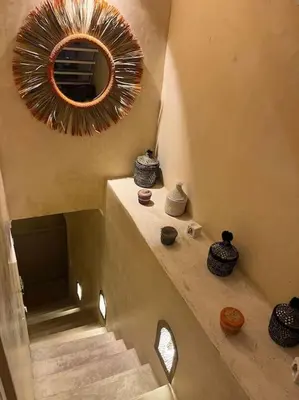 a staircase with vases and a mirror on the wall at Dar Mawa, a 1 min de Jemaa el Fna in Marrakech