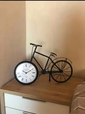 a bike sitting on top of a table with a clock at Studio au centre in Marrakech