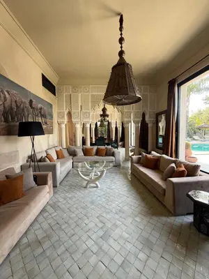 a living room with couches and a chandelier at Villa Jude in Marrakech