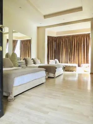 a large room with two beds and a large window at Villa Jude in Marrakech
