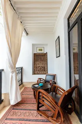 a living room with a table and chairs at Riad Rouge Gorge in Marrakech