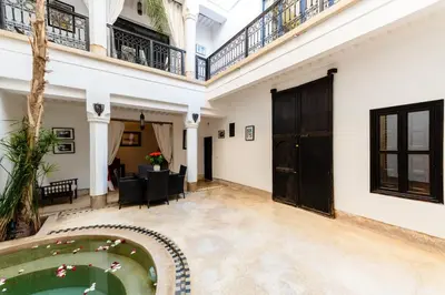 a courtyard with a pool in a house at Riad Rouge Gorge in Marrakech