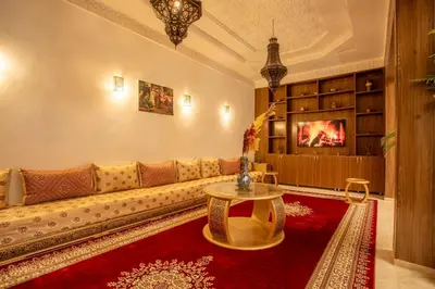 a living room with a couch and a table at Riad Kenza in Marrakech