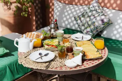 a tray of breakfast food on a table on a couch at Riad of the Moon in Marrakech