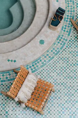 a lego bench on a tiled floor in a bathroom at Riad of the Moon in Marrakech