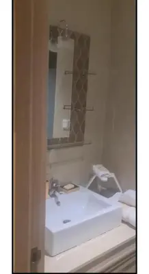 a bathroom with a white sink and a mirror at Appartement de rêve à Marrakech in Marrakech