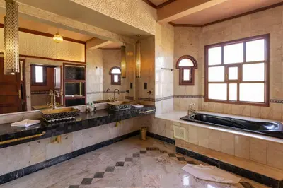 a large bathroom with two sinks and a tub at Nomadz Palace in Marrakech