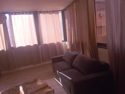 a living room with a couch and large windows at Hostel Ghali & Private Rooms Gueliz in Marrakech