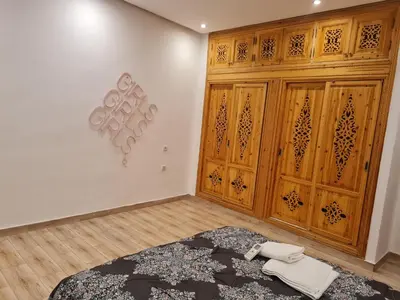 a room with a bed and wooden doors at Hostel Ghali & Private Rooms Gueliz in Marrakech