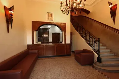 a living room with a staircase and a chandelier at HOTEL CTM in Marrakech