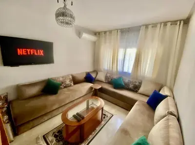 a living room with a couch and a table at Studio cosy au centre de Marrakech in Marrakech
