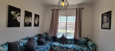 a living room with a couch and a window at Entre ville et détente- les portes de Guéliz in Marrakech