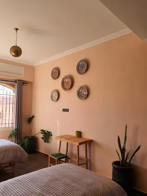 a bedroom with plates on the wall and a table at Maison Mamdy Rooftop in Marrakech